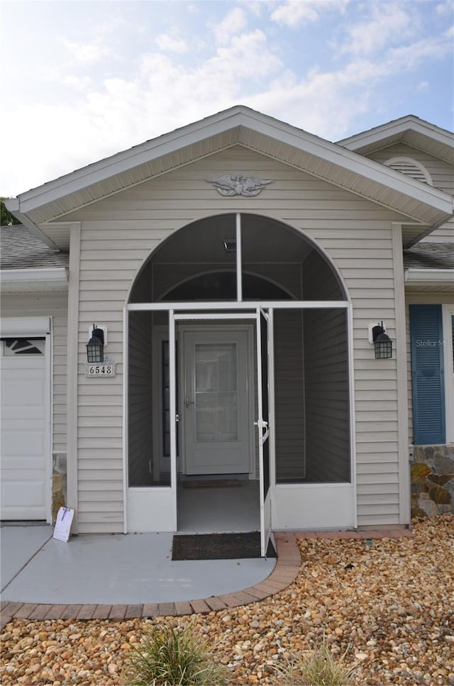 doorway to property featuring an attached garage