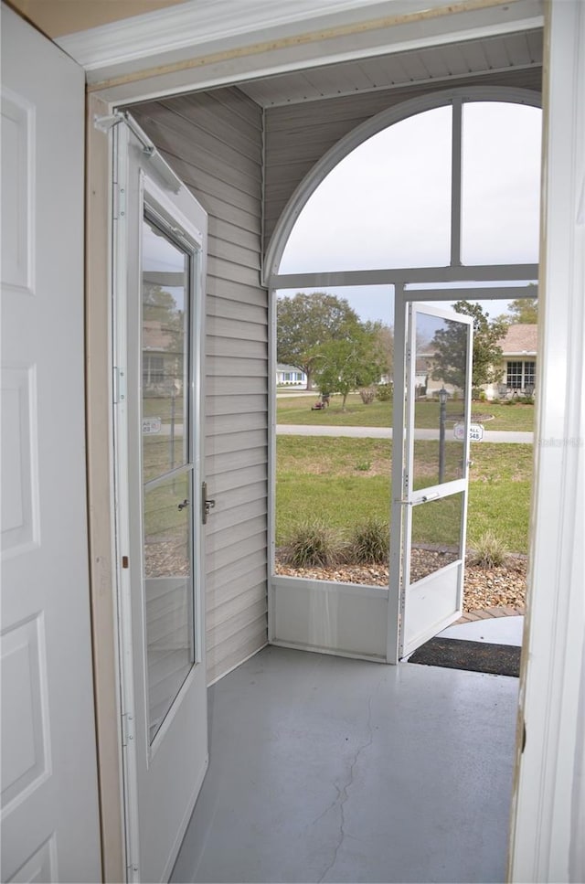 doorway to outside featuring finished concrete flooring