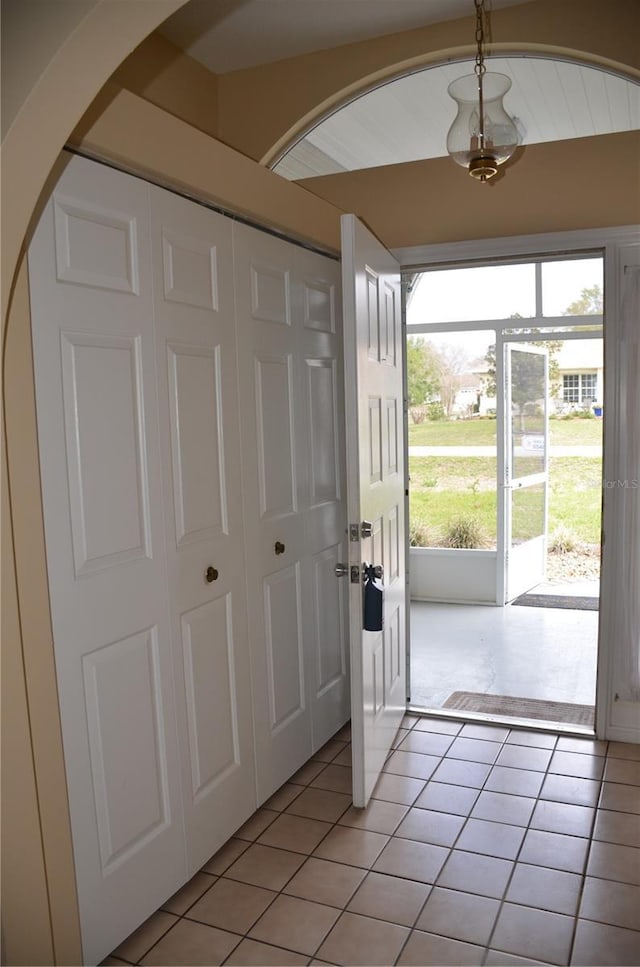 doorway to outside with light tile patterned floors