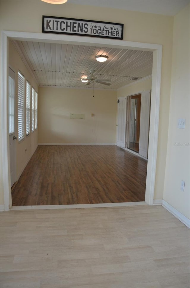 spare room featuring wood ceiling, baseboards, and wood finished floors