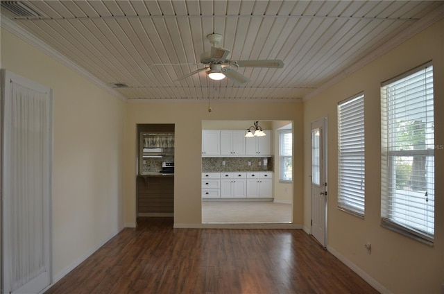 interior space with dark wood-style flooring, crown molding, visible vents, baseboards, and ceiling fan with notable chandelier