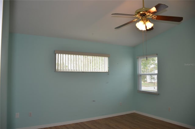 spare room featuring lofted ceiling, ceiling fan, wood finished floors, and baseboards