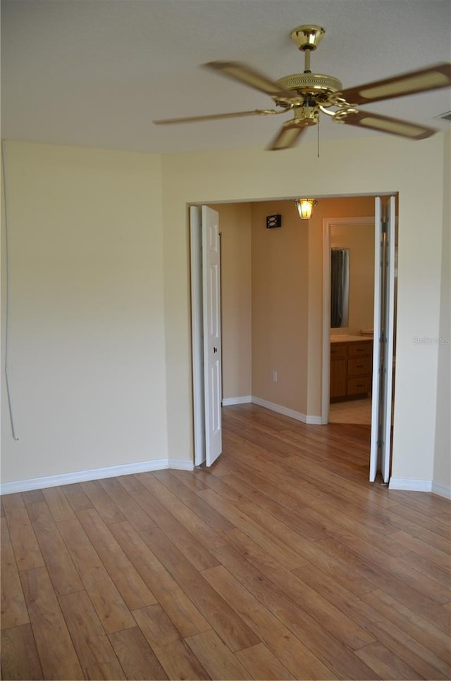 empty room with light wood-style floors, baseboards, and a ceiling fan