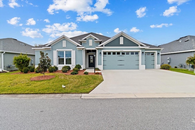 view of front facade with a garage, concrete driveway, a front lawn, and stucco siding