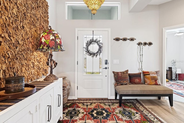 entryway featuring baseboards and wood finished floors