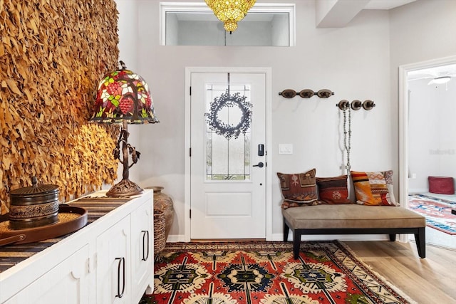 entryway with baseboards and wood finished floors