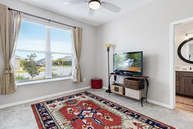 sitting room featuring carpet flooring, ceiling fan, and baseboards