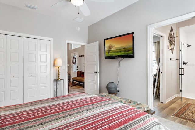 bedroom featuring a ceiling fan, a closet, visible vents, and wood finished floors