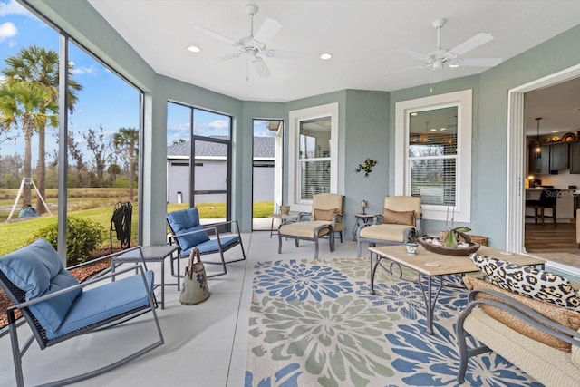 sunroom / solarium with a ceiling fan