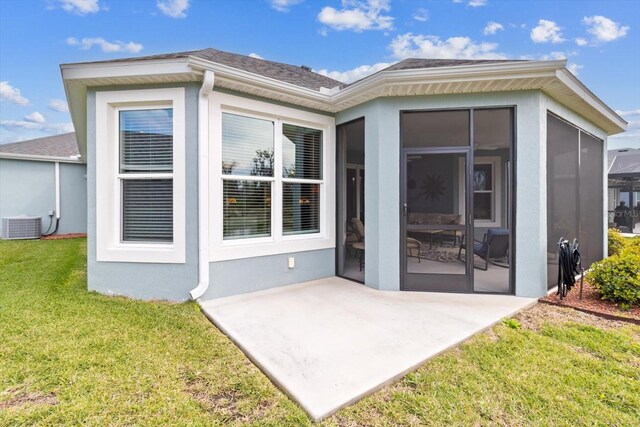 back of house with a patio, cooling unit, a sunroom, a yard, and stucco siding