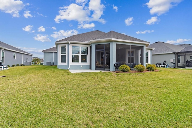 back of house featuring a sunroom and a yard