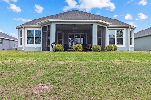 rear view of property with a yard, roof with shingles, cooling unit, and a sunroom