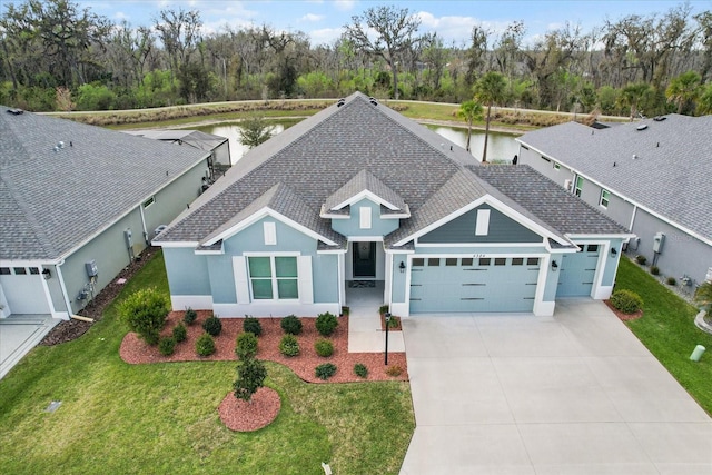 view of front of property with a shingled roof, concrete driveway, an attached garage, a front yard, and stucco siding