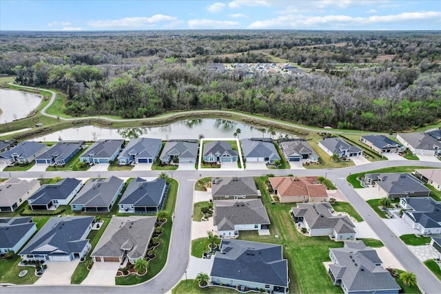 birds eye view of property with a water view and a residential view