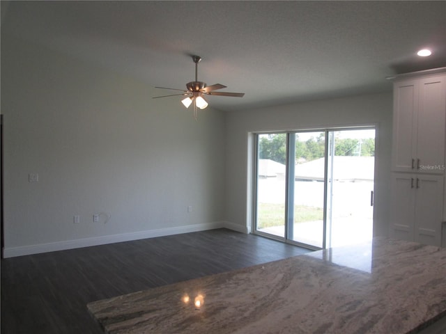 unfurnished room featuring baseboards, a ceiling fan, dark wood-type flooring, and recessed lighting