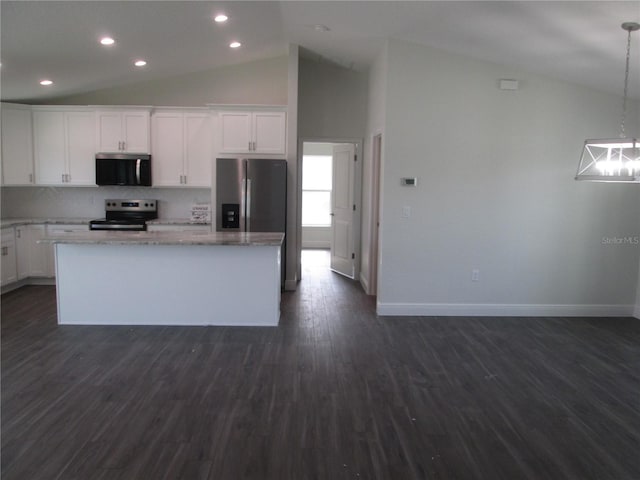 kitchen with dark wood-style floors, stainless steel appliances, a center island, baseboards, and decorative backsplash