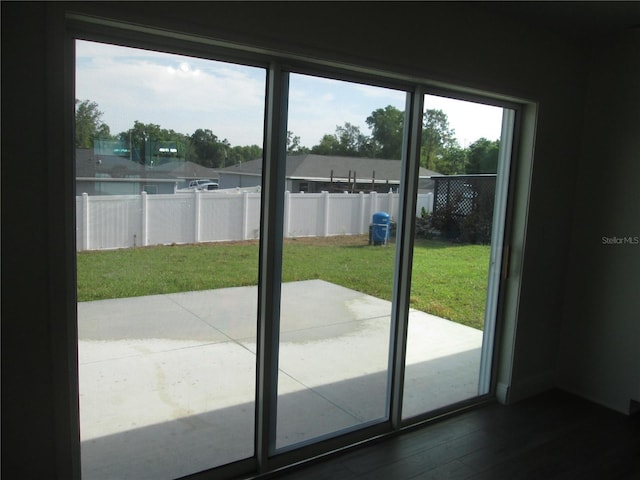 doorway to outside featuring dark wood-type flooring
