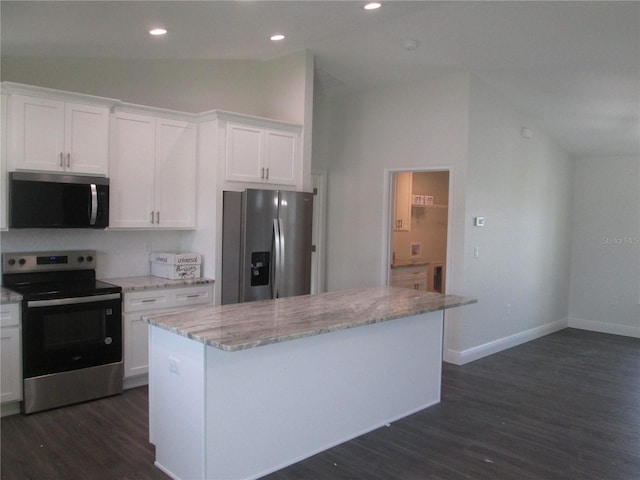 kitchen featuring dark wood finished floors, light stone counters, a kitchen island, appliances with stainless steel finishes, and white cabinetry