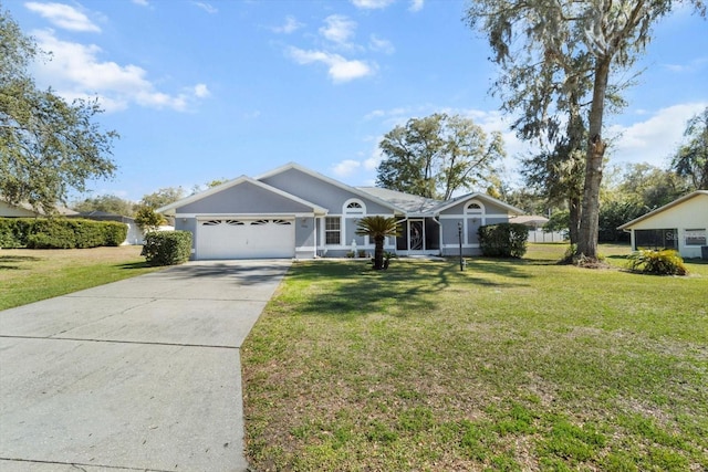 single story home featuring an attached garage, a front lawn, and concrete driveway