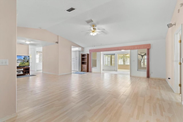 unfurnished living room featuring ceiling fan, visible vents, light wood-style flooring, and a wealth of natural light