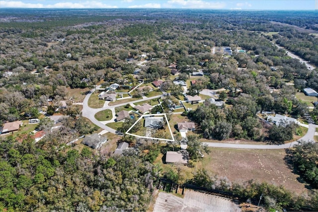 birds eye view of property with a wooded view