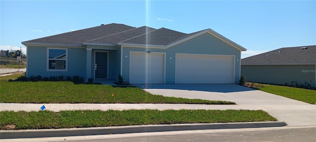 ranch-style house with a front yard, concrete driveway, and an attached garage