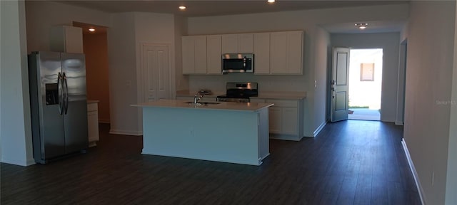 kitchen with stainless steel appliances, light countertops, white cabinetry, and dark wood-style floors