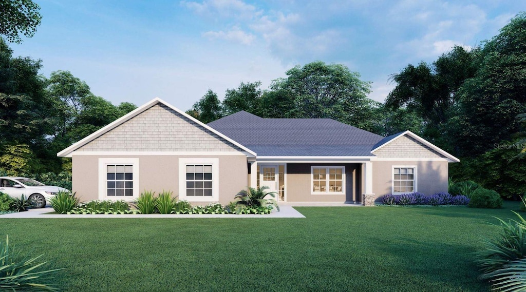 view of front of property featuring a front lawn and stucco siding