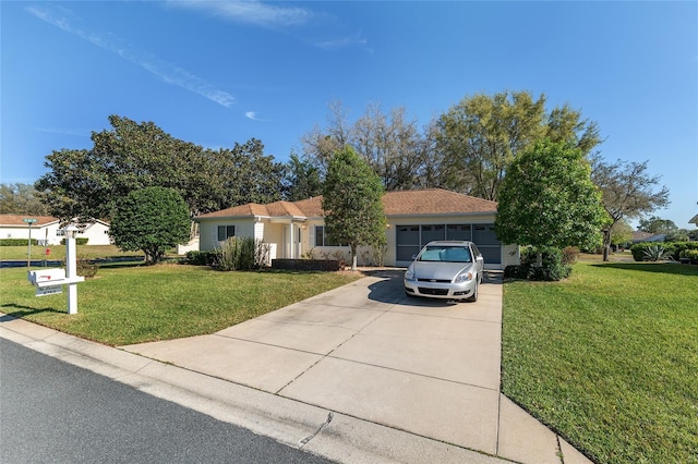 ranch-style home with an attached garage, concrete driveway, and a front yard