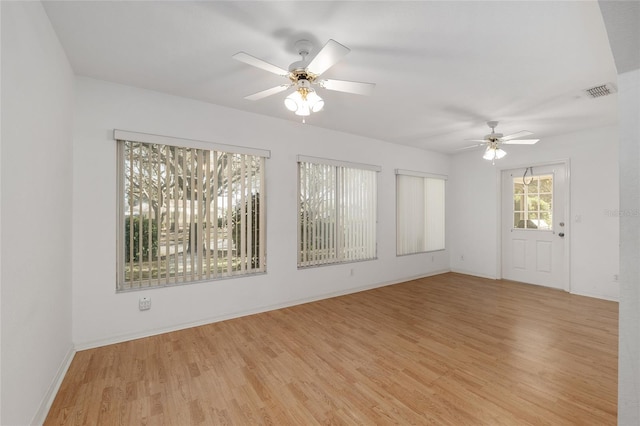 unfurnished room featuring visible vents, baseboards, light wood-style floors, and a ceiling fan