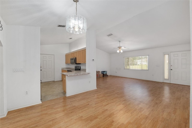 kitchen featuring visible vents, lofted ceiling, stainless steel appliances, light countertops, and open floor plan