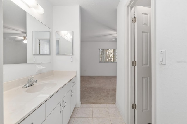 bathroom with tile patterned flooring, vanity, and ceiling fan