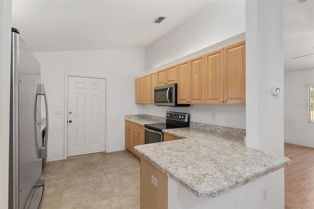 kitchen with visible vents, stainless steel appliances, a peninsula, light countertops, and lofted ceiling