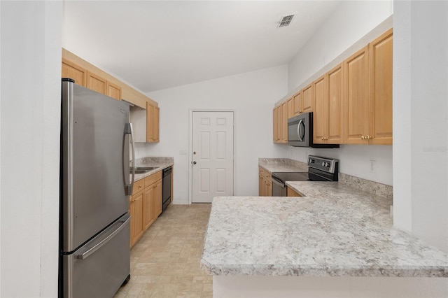 kitchen featuring visible vents, light brown cabinets, stainless steel appliances, and light countertops