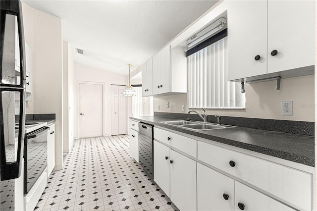 kitchen featuring visible vents, dishwasher, dark countertops, vaulted ceiling, and a sink