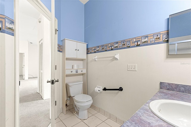 bathroom with vanity, tile patterned flooring, and toilet