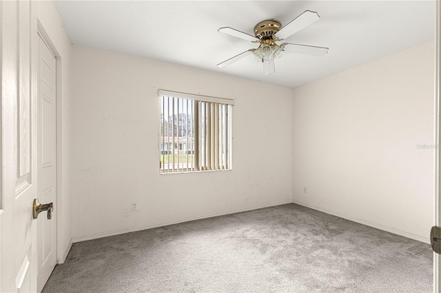 unfurnished room with a ceiling fan and carpet flooring