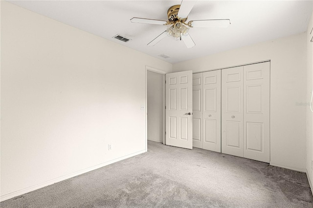 unfurnished bedroom with a closet, visible vents, carpet flooring, ceiling fan, and baseboards