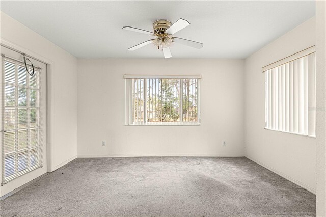 spare room featuring carpet floors and ceiling fan