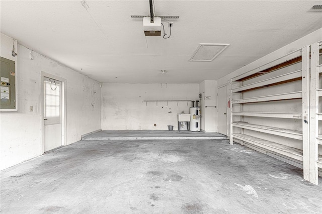 garage featuring electric panel, visible vents, and water heater