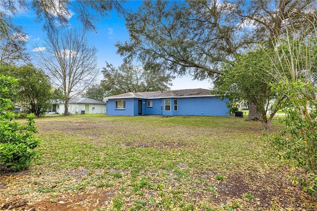 rear view of property with a lawn