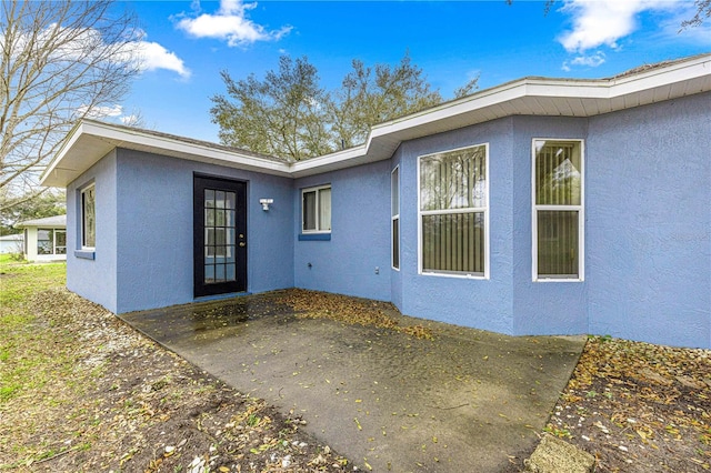 exterior space featuring stucco siding