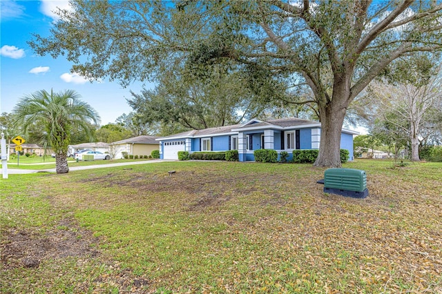 ranch-style house with a garage, driveway, and a front lawn