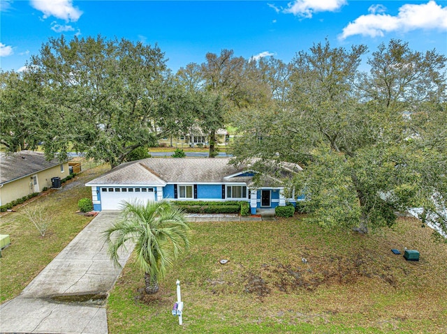 view of front of property with a garage, driveway, and a front yard