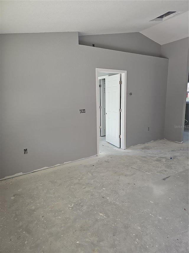 unfurnished room with lofted ceiling and visible vents