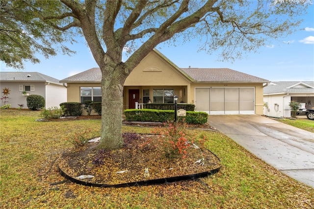 ranch-style house featuring a garage, a front yard, concrete driveway, and stucco siding