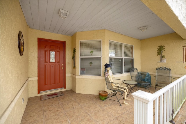 view of exterior entry featuring stucco siding