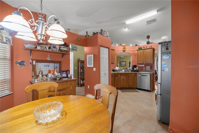 dining space featuring lofted ceiling, an inviting chandelier, visible vents, and a textured ceiling