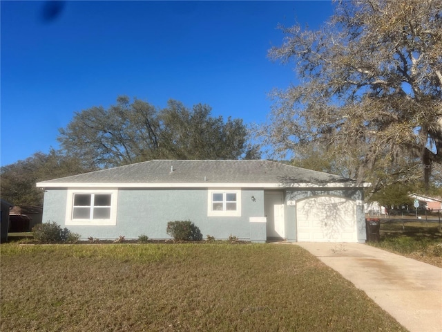 ranch-style home with a garage, concrete driveway, a front lawn, and stucco siding