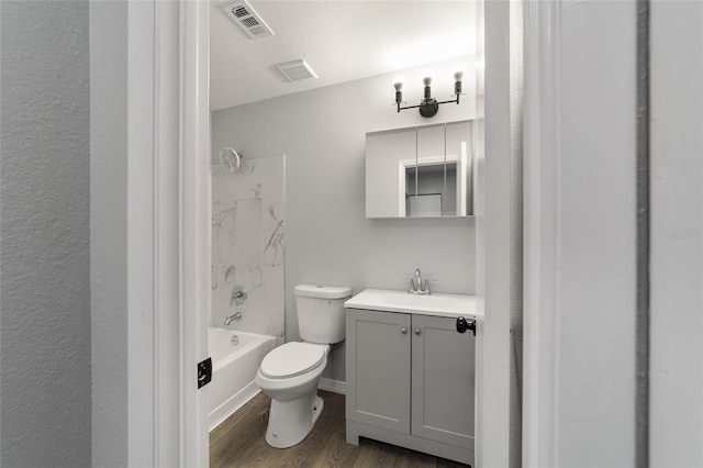 bathroom with toilet, visible vents, wood finished floors, and vanity